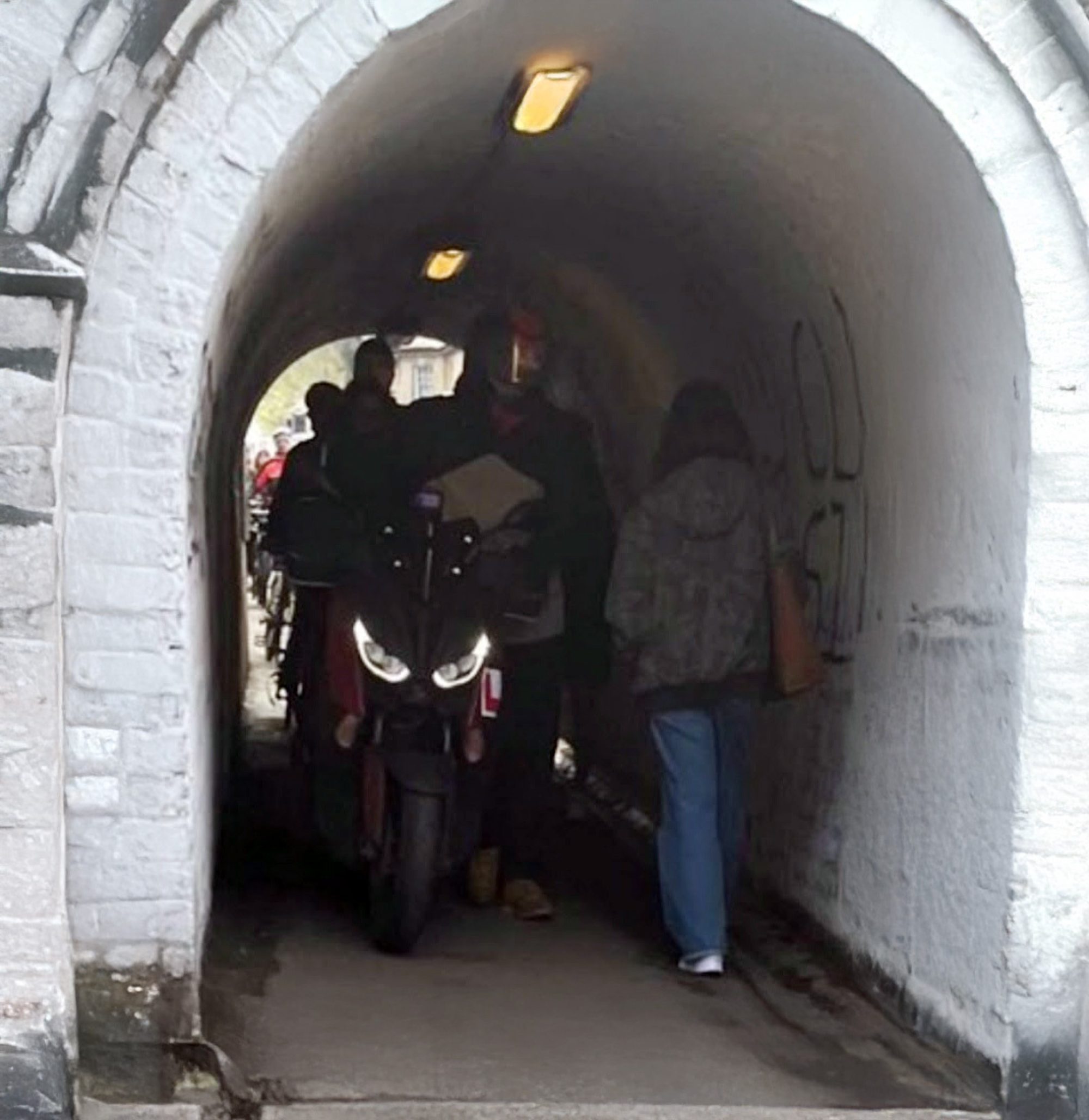 Photo of motorbike in small tunnel for pedestrians