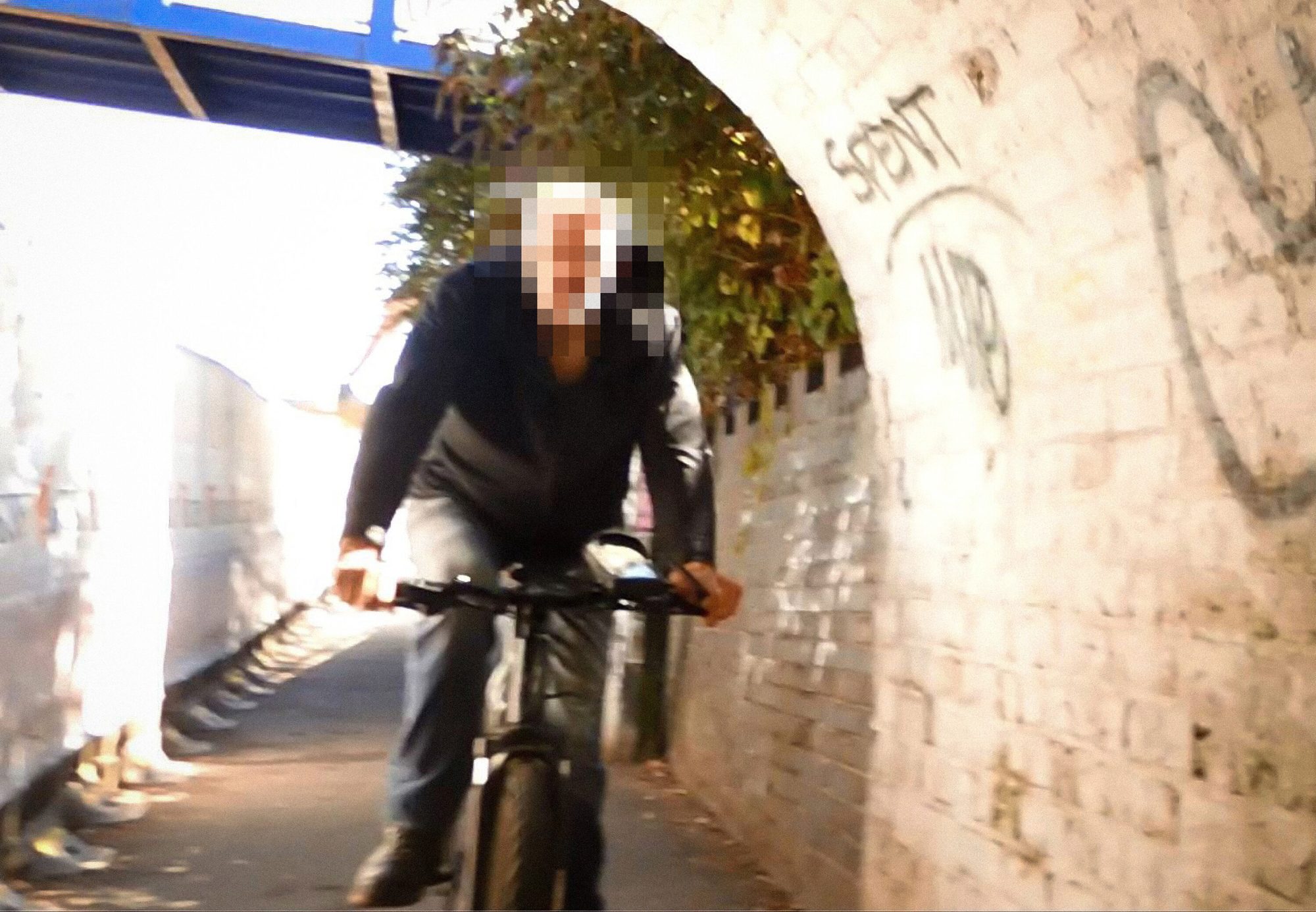 Cyclist riding through small tunnel